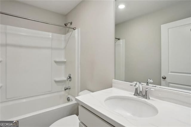 full bathroom with toilet, vanity, and shower / washtub combination