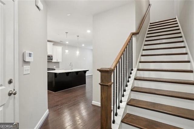 staircase featuring hardwood / wood-style flooring