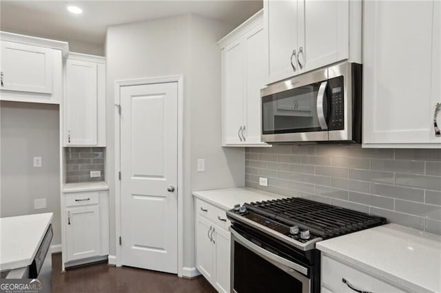 kitchen with stainless steel appliances, decorative backsplash, and white cabinets