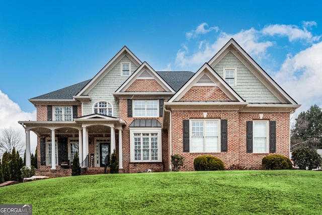 craftsman-style home with covered porch and a front lawn