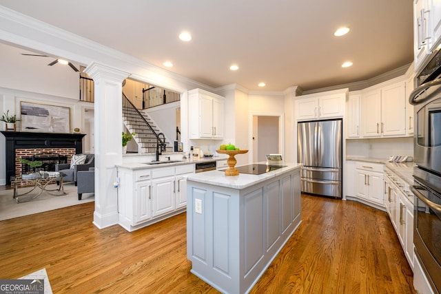 kitchen with white cabinets, appliances with stainless steel finishes, and a center island