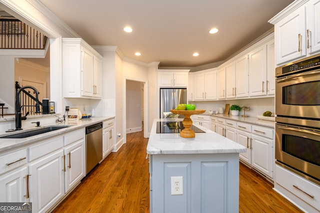 kitchen featuring white cabinets, a center island, and appliances with stainless steel finishes