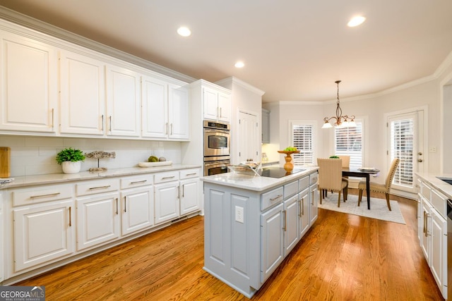 kitchen featuring a center island, backsplash, and white cabinetry