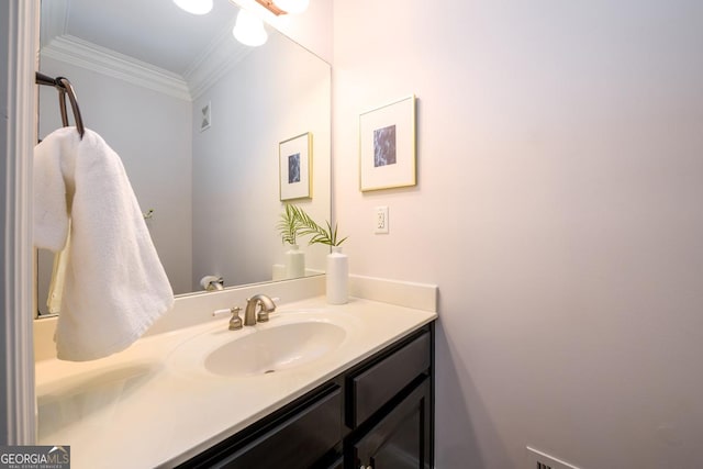 bathroom featuring crown molding and vanity