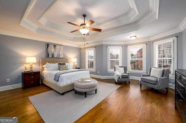 bedroom with ceiling fan, ornamental molding, and a raised ceiling