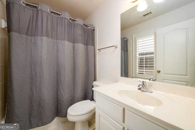 bathroom with curtained shower, tile patterned floors, vanity, and toilet