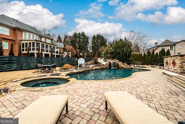 view of swimming pool with an in ground hot tub and a patio