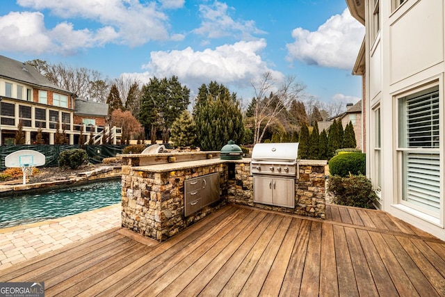 wooden deck with a patio, grilling area, and area for grilling