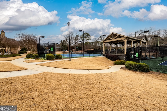 surrounding community featuring tennis court and a gazebo