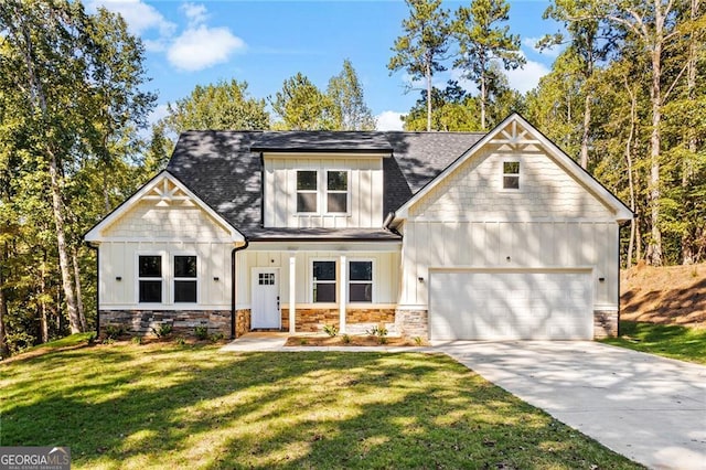 view of front of home featuring a garage, concrete driveway, board and batten siding, and a front yard