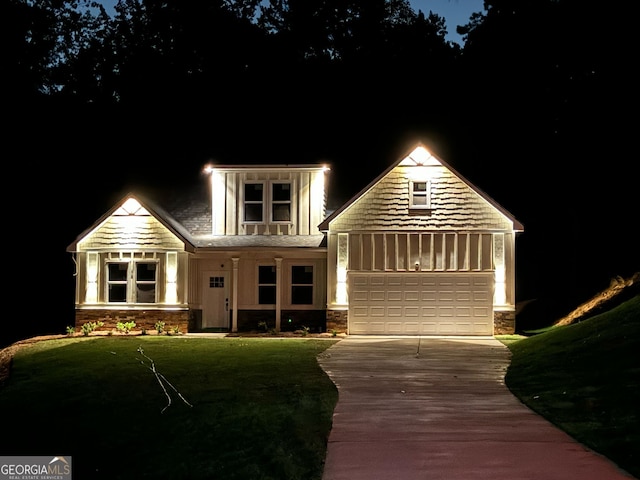 view of front of house with a garage, concrete driveway, and stone siding