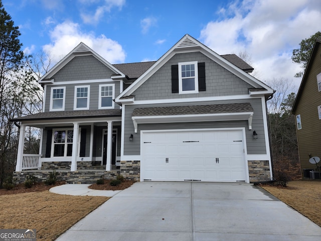 craftsman-style home with a porch and a garage