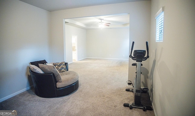 exercise room featuring light carpet and ceiling fan