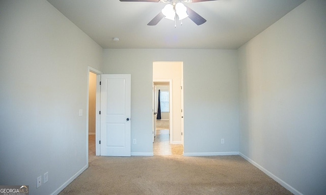 unfurnished bedroom with ceiling fan and light colored carpet