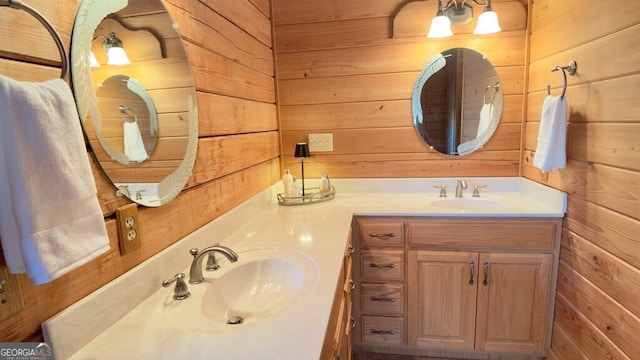 full bath featuring wood walls, a sink, and double vanity