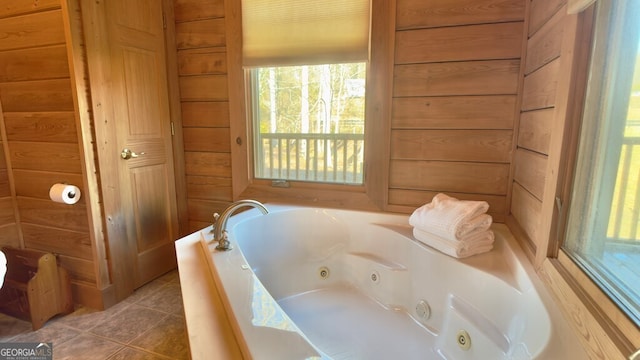 full bath with a tub with jets, wood walls, and tile patterned floors