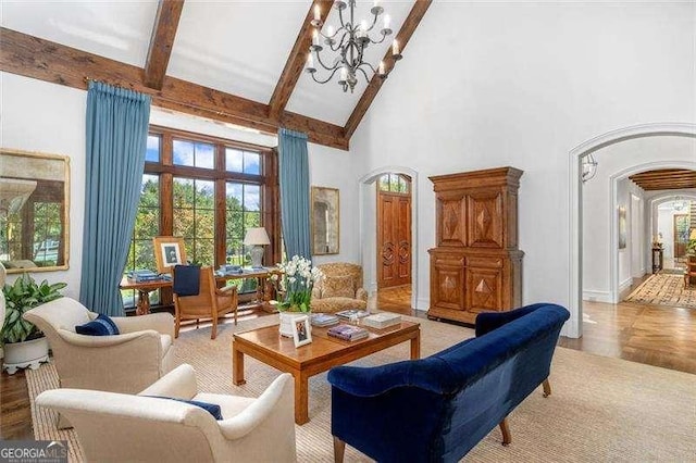 living room featuring beamed ceiling, a towering ceiling, and a notable chandelier