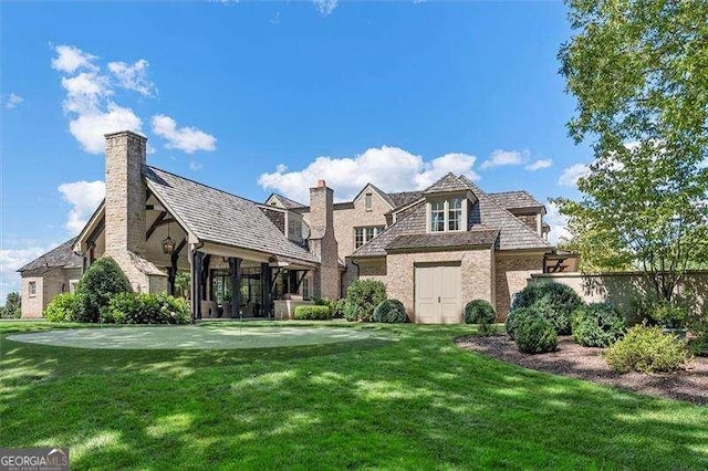 rear view of property featuring a yard