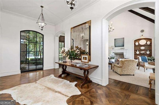 entrance foyer with dark parquet flooring, crown molding, and a notable chandelier