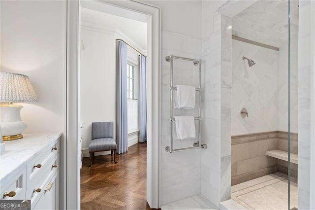 bathroom featuring parquet flooring, walk in shower, and vanity