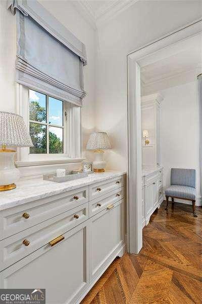 interior space featuring ornamental molding and parquet floors