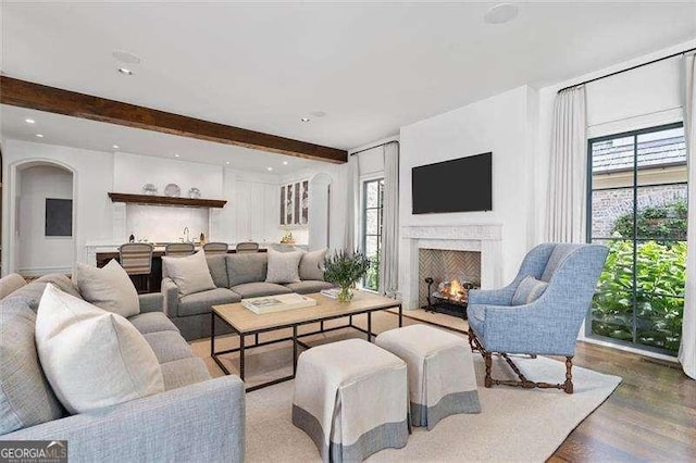 living room featuring hardwood / wood-style flooring, plenty of natural light, and beam ceiling