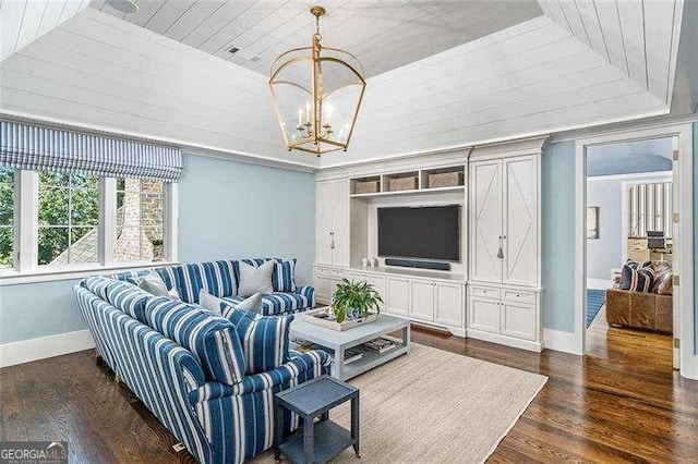 living room featuring dark wood-type flooring, a notable chandelier, and wooden ceiling