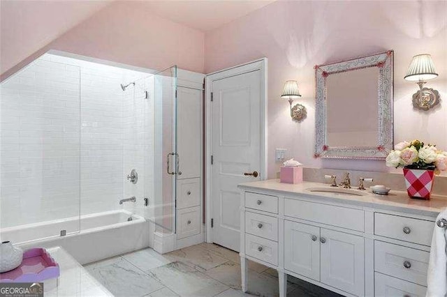 bathroom featuring tiled shower / bath combo and vanity