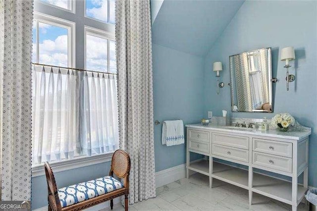 bathroom featuring vanity and vaulted ceiling