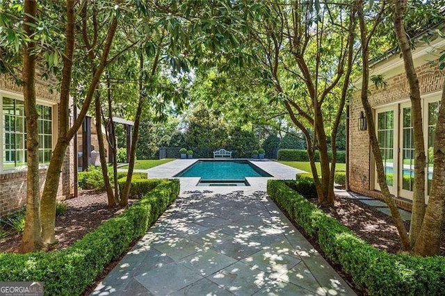 view of swimming pool featuring a patio area