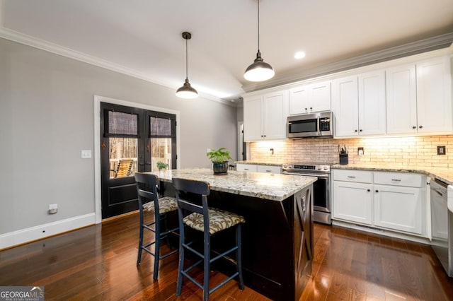 kitchen featuring a kitchen island, white cabinets, and appliances with stainless steel finishes