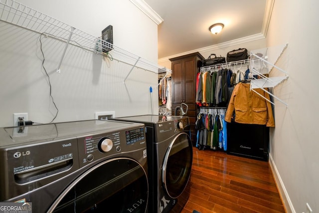 washroom featuring crown molding, independent washer and dryer, and dark hardwood / wood-style flooring