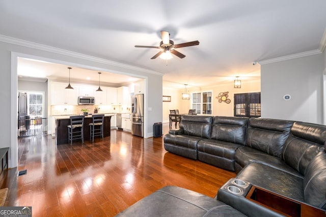 living room featuring crown molding, dark hardwood / wood-style floors, and ceiling fan