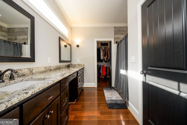 bathroom with vanity, hardwood / wood-style floors, and ornamental molding