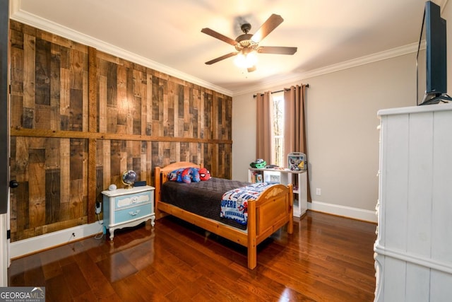 bedroom featuring dark hardwood / wood-style flooring, ornamental molding, ceiling fan, and wood walls