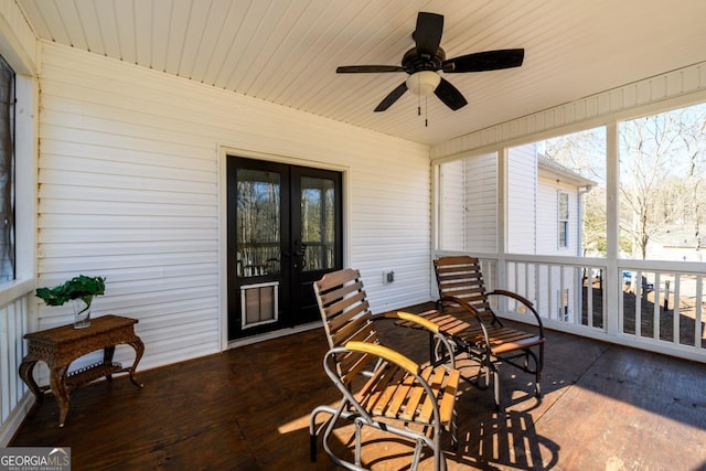 sunroom / solarium with ceiling fan and french doors