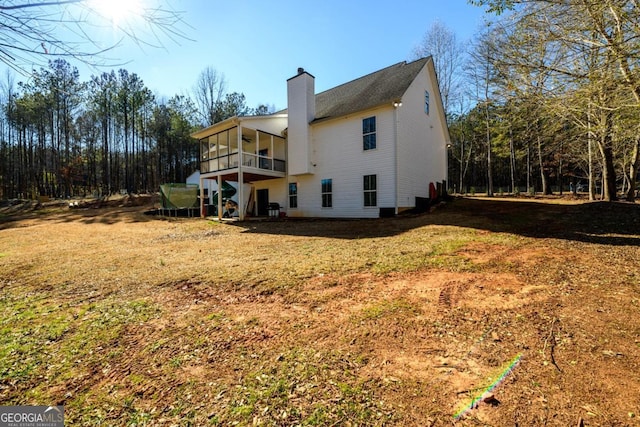 back of house featuring a lawn