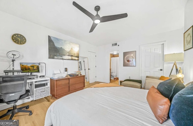 bedroom with ceiling fan, light hardwood / wood-style floors, and ensuite bath