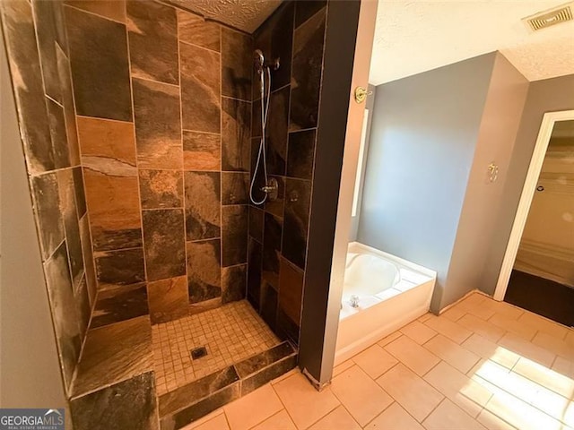 bathroom with tile patterned floors and shower with separate bathtub