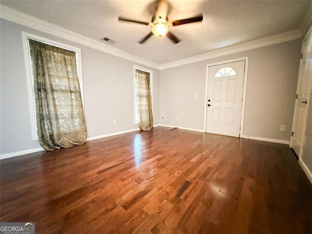 foyer featuring ceiling fan, ornamental molding, and dark hardwood / wood-style floors