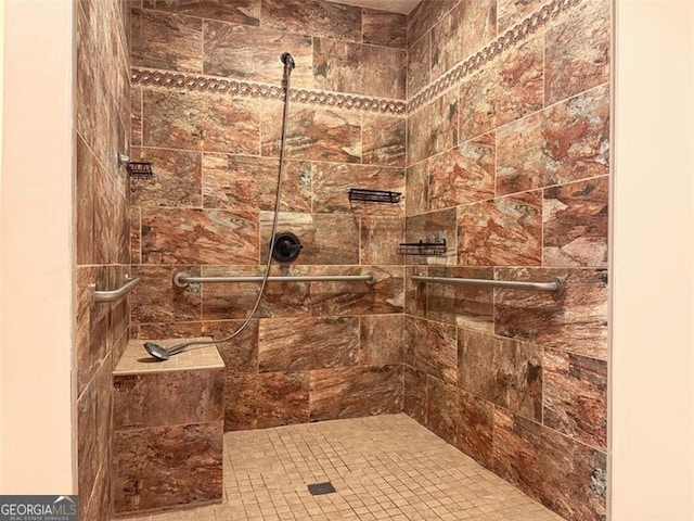 bathroom with tiled shower