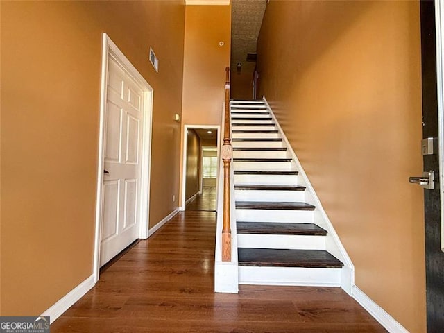 stairs featuring hardwood / wood-style flooring