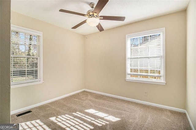 carpeted empty room featuring ceiling fan