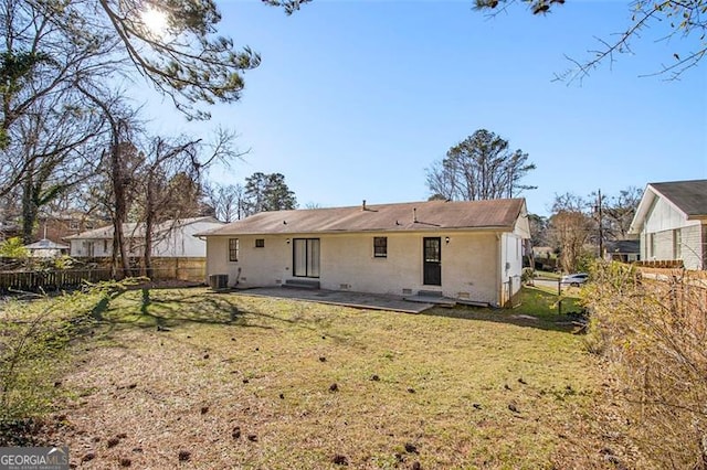 back of house featuring a lawn, central air condition unit, and a patio area