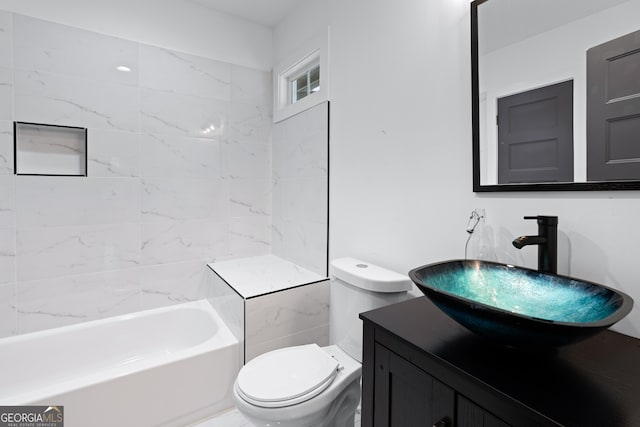 full bathroom with vanity, tiled shower / bath combo, and toilet