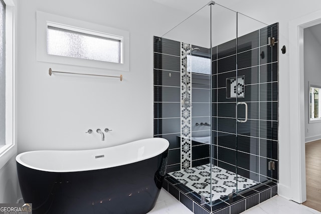 bathroom featuring separate shower and tub