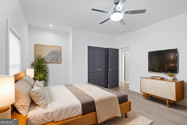 bedroom with ceiling fan and light wood-type flooring