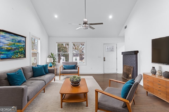 living room with dark hardwood / wood-style flooring, high vaulted ceiling, and ceiling fan