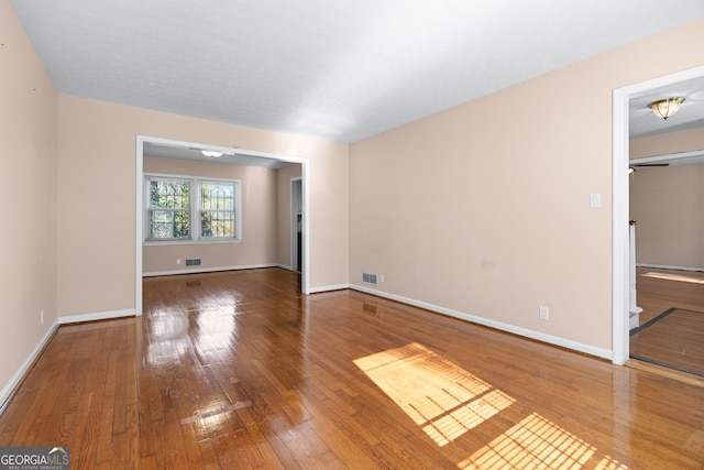 unfurnished room featuring hardwood / wood-style flooring