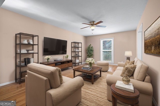 living room featuring hardwood / wood-style floors and ceiling fan